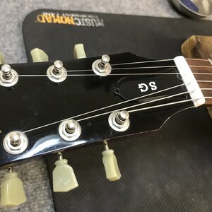 Repairing guitar to fix fret buzz