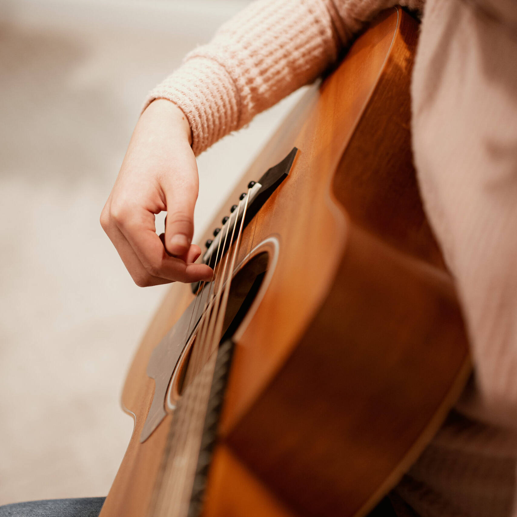 Picture of a student playing a guitar