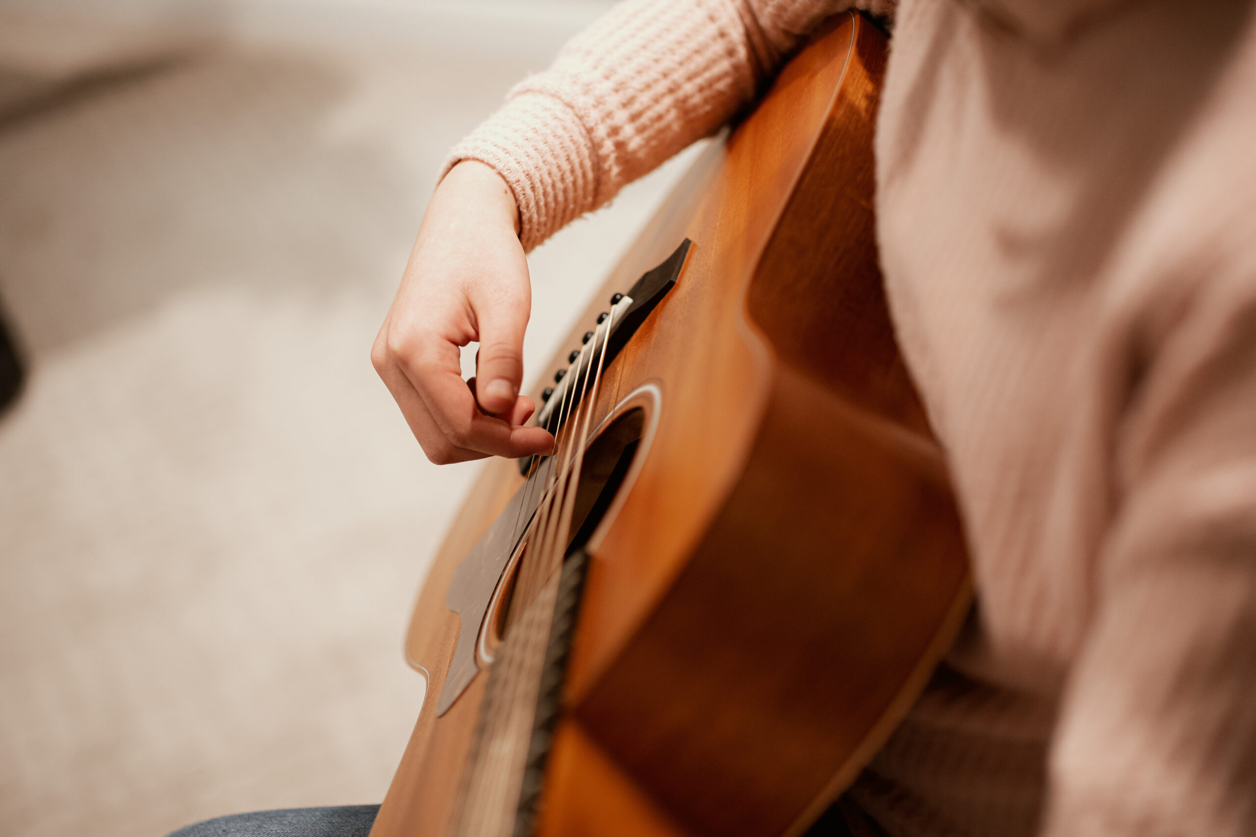 Picture of a student playing a guitar